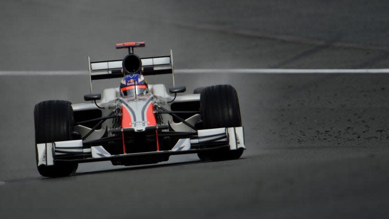 A photo of Daniel Ricciardo driving an HRT Formula 1 car. 
