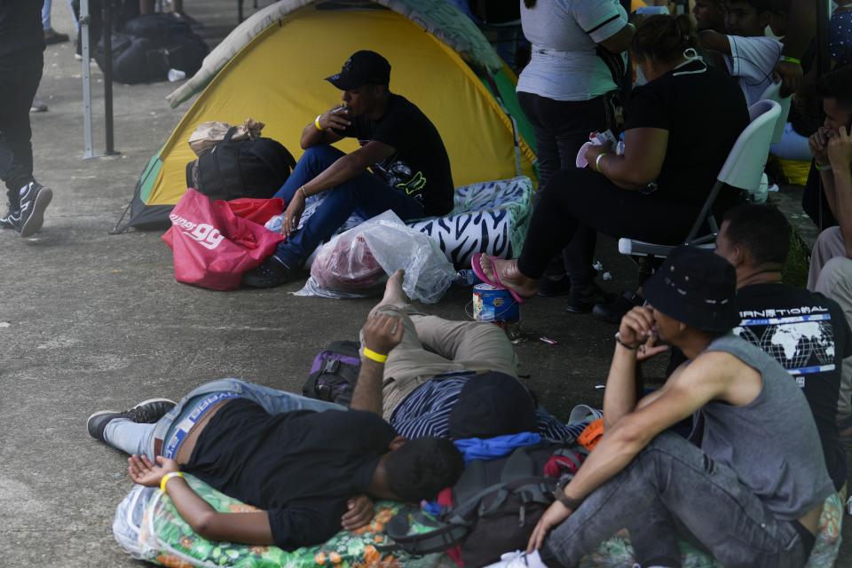 Venezuelan migrants hoping to return to their country of origin, wait at a commercial warehouse being used as a temporary shelter, in Panama City, Wednesday, Oct. 26, 2022. (AP Photo/Arnulfo Franco)
