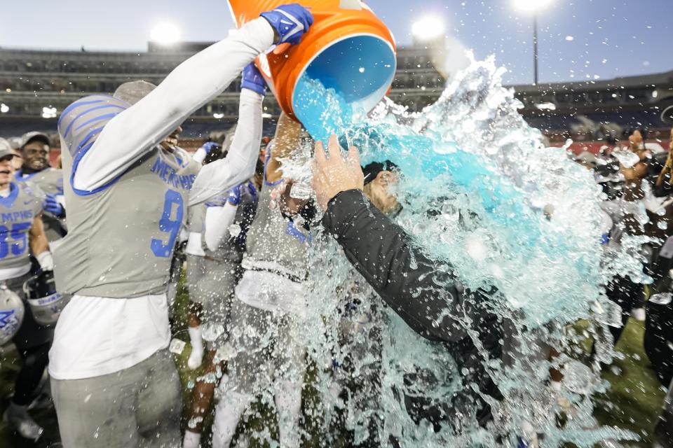 Memphis head coach Ryan Silverfield is doused with water following the First Responder Bowl NCAA college football game against Utah State, Tuesday, Dec. 27, 2022, in Dallas. Memphis won 38-10. (AP Photo/Sam Hodde)