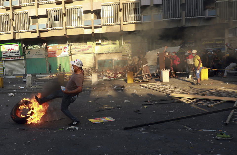 Anti-government protesters set fire and close streets during ongoing protests in Baghdad, Iraq, in central Baghdad, Iraq, Saturday, Nov. 9, 2019. Iraqi security forces killed several anti-government protesters and wounded others on Saturday, pushing them back from three flashpoint bridges in central Baghdad, medical and security officials said. (AP Photo/Hadi Mizban)