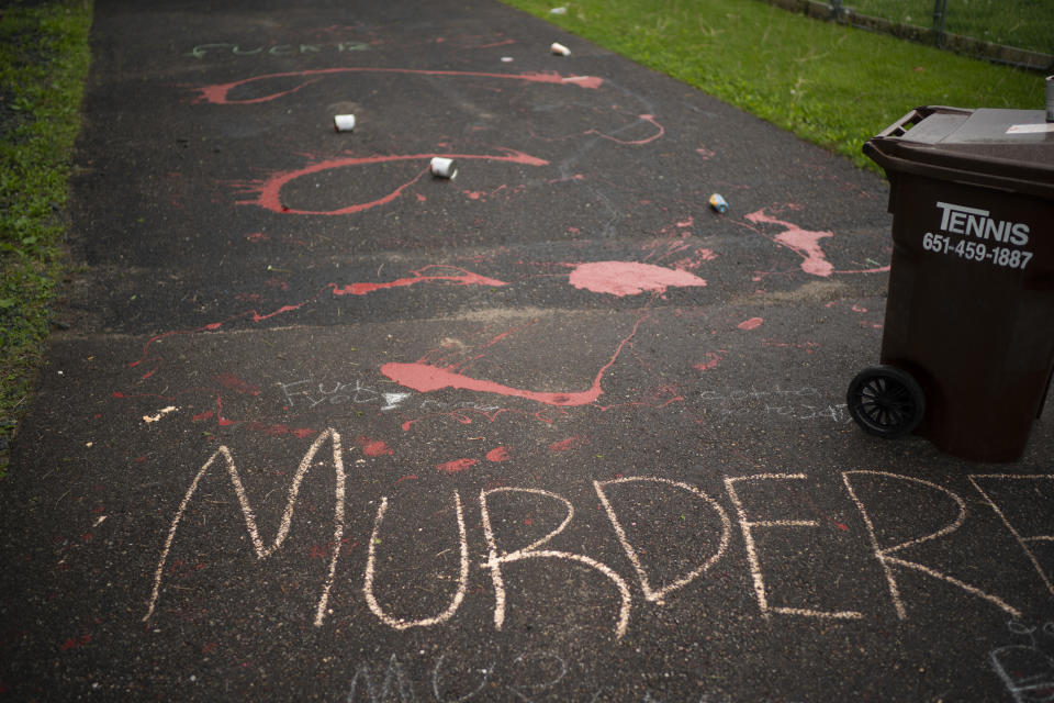 Splattered paint and chalk writing are on the driveway of the home of fired Minneapolis police Officer Derek Chauvin in Oakdale, Minn., Wednesday, May 27, 2020. The mayor of Minneapolis called Wednesday for criminal charges against Chauvin, the white police officer seen on video kneeling against the neck of Floyd George, a handcuffed black man who complained that he could not breathe and died in police custody. (Jeff Wheeler/Star Tribune via AP)