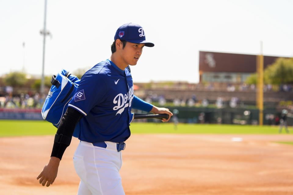 Los Angeles Dodgers designated hitter Shohei Ohtani walks to the dugout before a spring training baseball game against the Arizona Diamondbacks, Sunday, March 10, 2024, in Phoenix. (AP Photo/Lindsey Wasson)