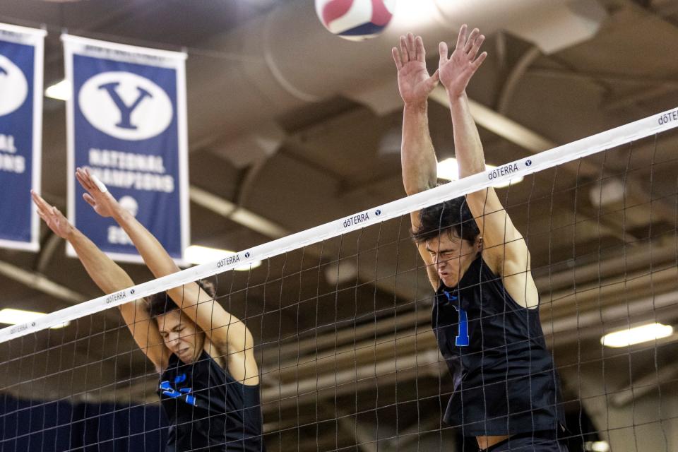 Brigham Young Cougars middle blocker Teon Taylor (21) and outside hitter Luke Benson (1) block a shot during an NCAA men’s volleyball match against the Long Island Sharks at the Smith Fieldhouse in Provo on Thursday, Feb. 8, 2023. | Marielle Scott, Deseret News