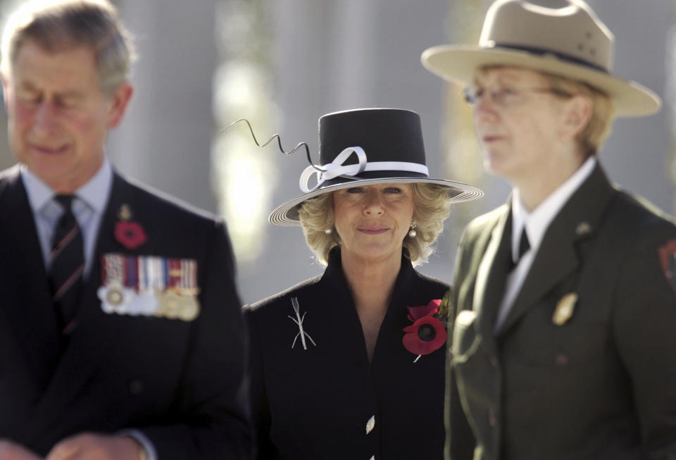 FILE - Camilla, Duchess of Cornwall, center, Britain's Prince Charles, left, and Vikki Keys, Superintendent of the National Mall and Memorial Parks visit the World War II Memorial in Washington, Friday, Nov. 4, 2005. Britain's queen consort, Camilla, has come a long way. On May 6, she will be crowned alongside her husband and officially take her first turns on the world stage as Queen Camilla. (Jason Reed, Pool Photo via, File)