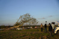 EPA Administrator Michael Regan stands near a cemetery in a neighborhood next to the Nu Star Energy oil storage tanks, as he conducts a television interview, in St. James Parish, La., Tuesday, Nov. 16, 2021. Regan visited St. John and St. James parishes on a tour he called "Journey to Justice." The five-day trip from Mississippi to Texas in mid-November highlighted low-income, mostly minority communities adversely affected by decades of industrial pollution. (AP Photo/Gerald Herbert)