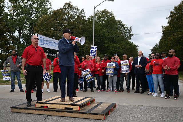 <p>JIM WATSON/AFP via Getty</p> US President Joe Biden addresses striking members of the United Auto Workers (UAW) union at a picket line outside a General Motors Service Parts Operations plant in Belleville, Michigan, on September 26, 2023