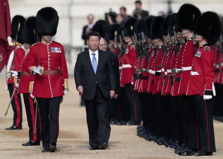 China's President Xi Jinping and Britain's Prince Philip review an honour guard during his official welcoming ceremony in London, Britain, October 20, 2015. Xi is on a State visit to Britain. REUTERS/Suzanne Plunkett