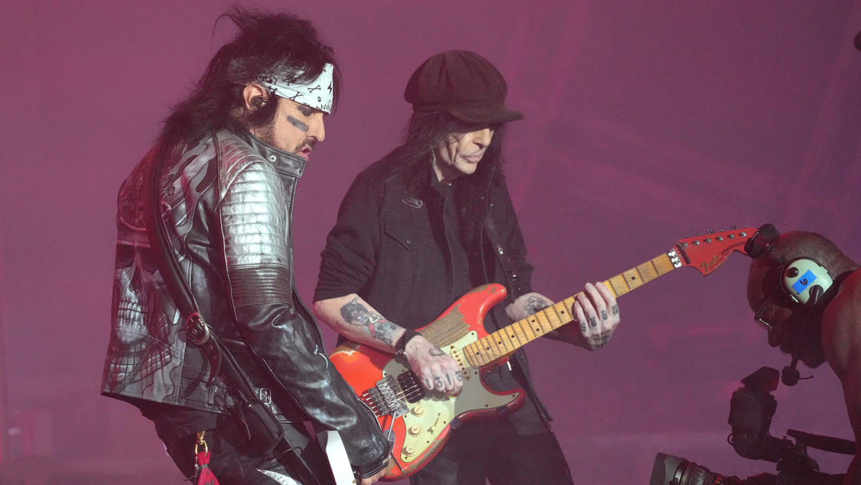  Nikki Sixx (left) and Mick Mars onstage with Mötley Crüe in 2022 