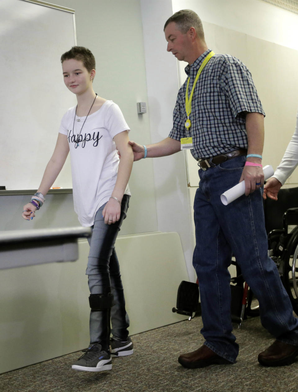 FILE - In this April 20, 2017, file photo, Matt Turner aids his daughter Deserae Turner, as they arrive for a news conference at Primary Children's Hospital, in Salt Lake City. Turner, a Utah high school student who survived a gunshot wound to the head was named homecoming queen by her classmates. Turner was found in a ditch after being shot in the back of the head and left for dead by two classmates in February 2017. (AP Photo/Rick Bowmer, File)