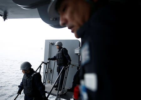 A female member of ship boarding inspection team from Japanese helicopter carrier Kaga (C) takes part in a training exercise in the Indian Ocean, September 29, 2018. REUTERS/Kim Kyung-Hoon