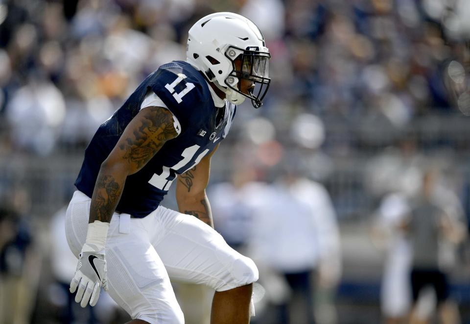 FILE - In this April 21, 2018, file photo, Penn State linebacker Micah Parsons follows a player during the NCAA college football game's Blue-White Game on in State College, Pa. Last year, Parsons put together the greatest freshman season for a linebacker in Penn State’s long history. He says he learned that earning a starting spot takes more than making a bunch of tackles. (Abby Drey/Centre Daily Times via AP, File)