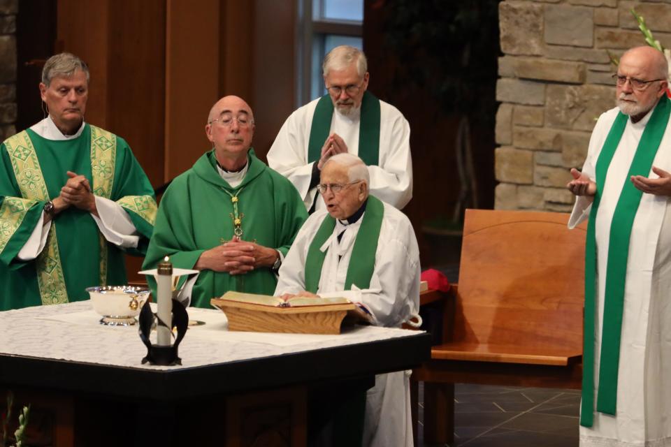 Fr. Edward Sippel, seated here at Holy Family Catholic Church, offered a special Mass June 25 in celebration of both his 100th birthday and 75th anniversary of his ordination into priesthood.