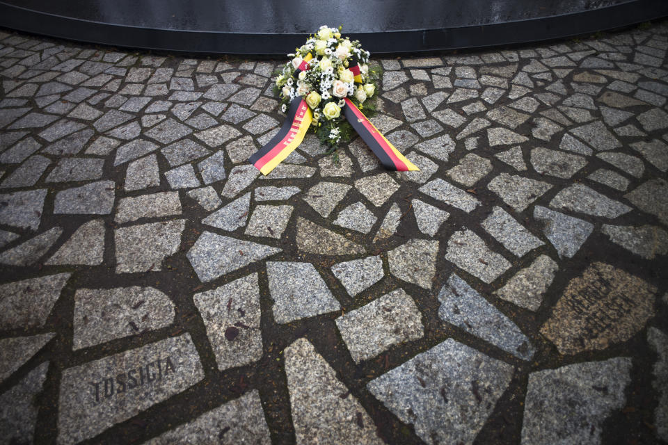 Flowers are placed at the Memorial to the Sinti and Roma Victims of the Holocaust on the International Holocaust Remembrance Day, in Berlin, Germany, Wednesday, Jan. 27, 2021. (AP Photo/Markus Schreiber)