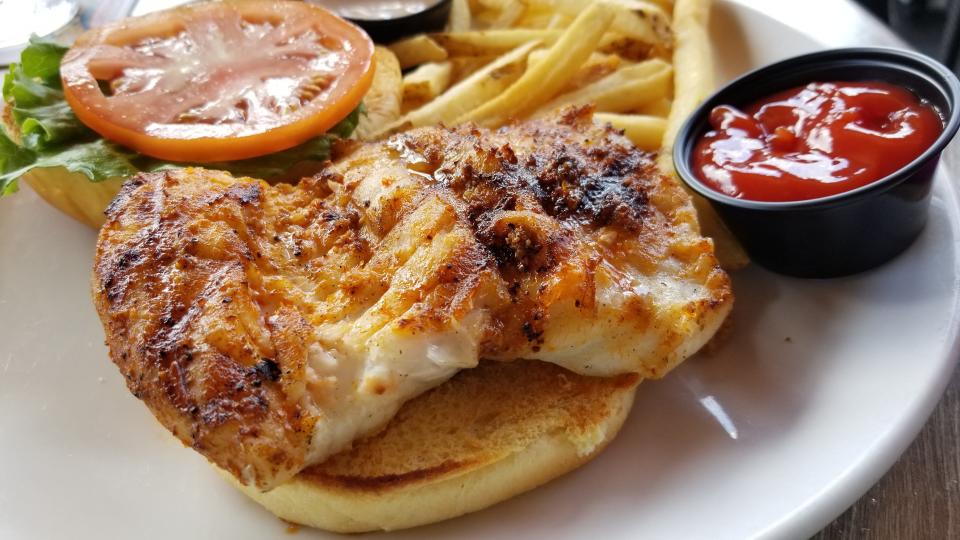 Blackened grouper sandwich with fries at Dry Dock Waterfront Grill on Longboat Key. Not pictured, the side of sweet chili sauce.