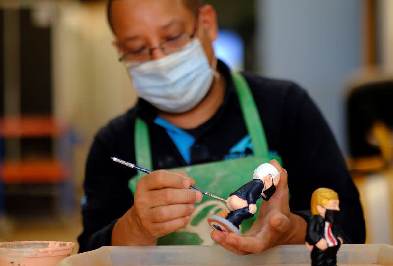 A worker paints a U.S. Democratic presidential candidate Biden "caganer", in a pottery in Torroella de Montgri