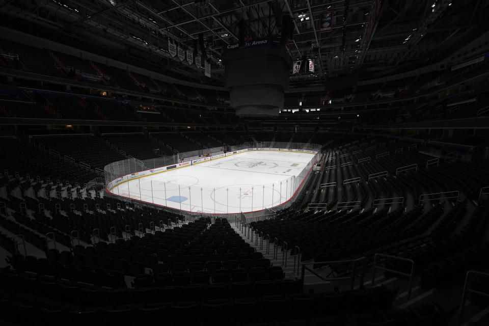 FILE - In this March 12, 2020, file photo, the Capital One Arena, home of the Washington Capitals NHL hockey club, sits empty in Washington. With no games being played, recent sports headlines have centered around hopes and dreams — namely, the uncharted path leagues and teams must navigate to return to competition in the wake of the pandemic. (AP Photo/Nick Wass, File)