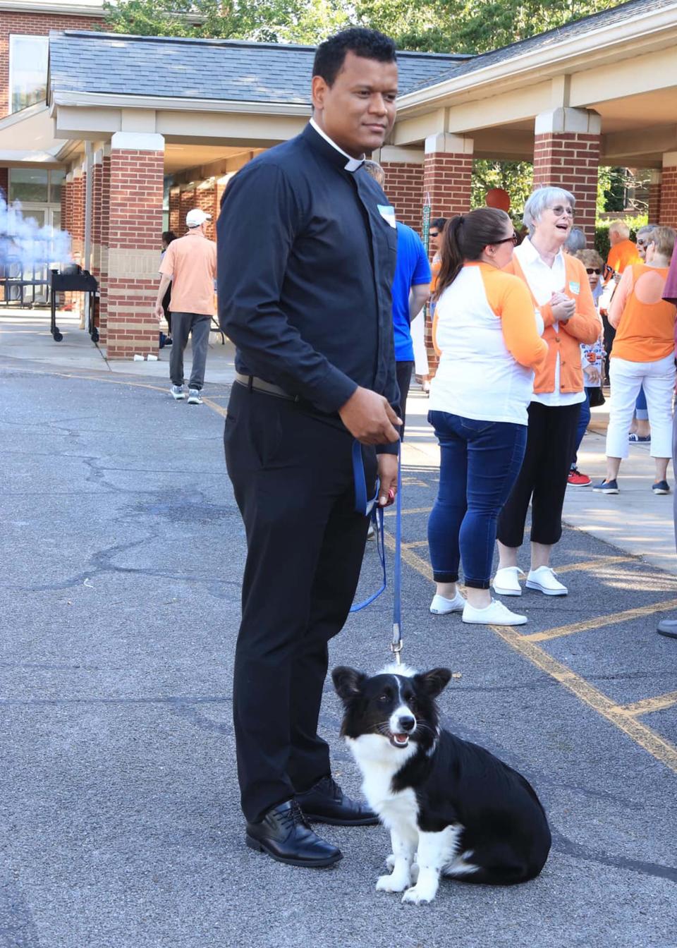 The atmosphere at the All Saints Catholic Church Adult Social “Tailgates and Touchdowns” was so friendly and laid back, Father Jorge Mejia brought his dog Dodi to enjoy the festivities. Aug. 11, 2023.