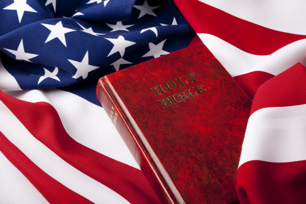 Holy Bible on American Flag For religion And Politics Concept