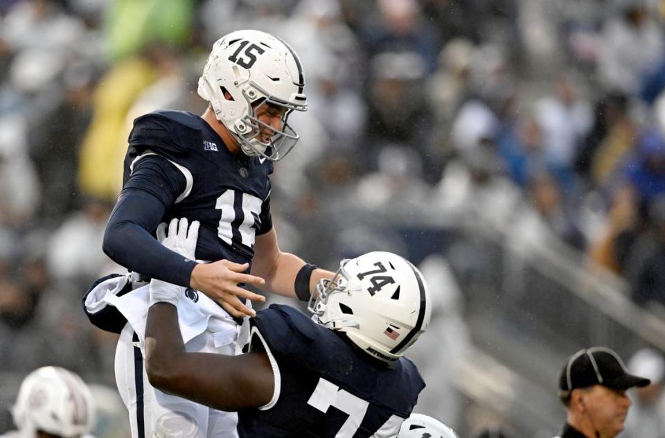 Penn State offensive lineman Olumuyiwa Fashanu lifts up quarterback Drew Allar to celebrate his touchdown during the game against UMass on Saturday, Oct. 14, 2023. Abby Drey/adrey@centredaily.com