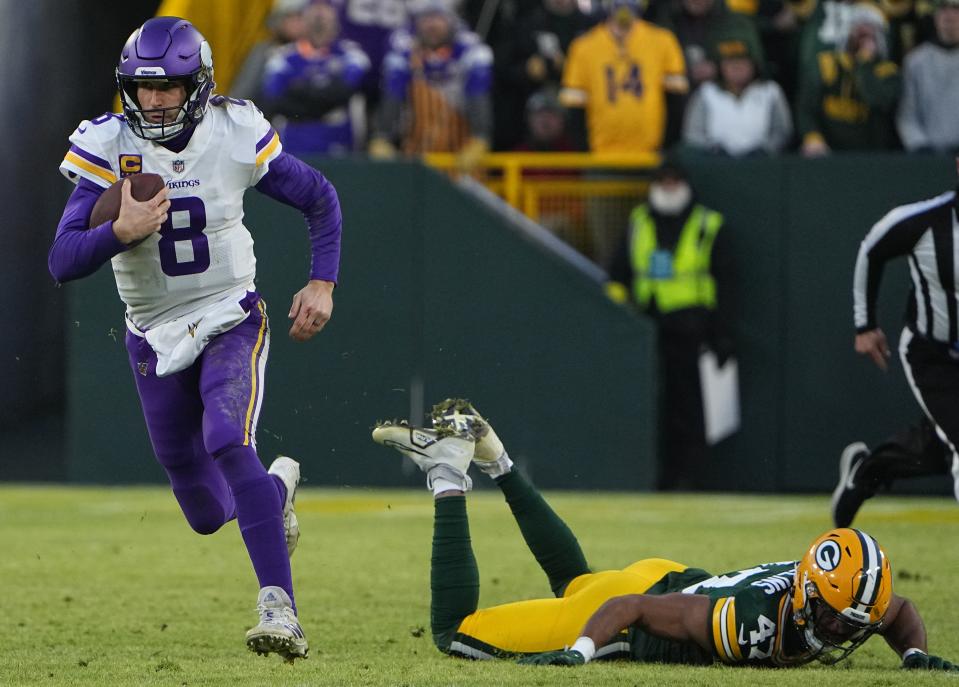 Minnesota Vikings quarterback Kirk Cousins (8) scrambles for 20 yards during the first quarter of their game Sunday, January 1, 2023 at Lambeau Field in Green Bay, Wis. The Green Bay Packers beat the Minnesota Vikings 41-17.