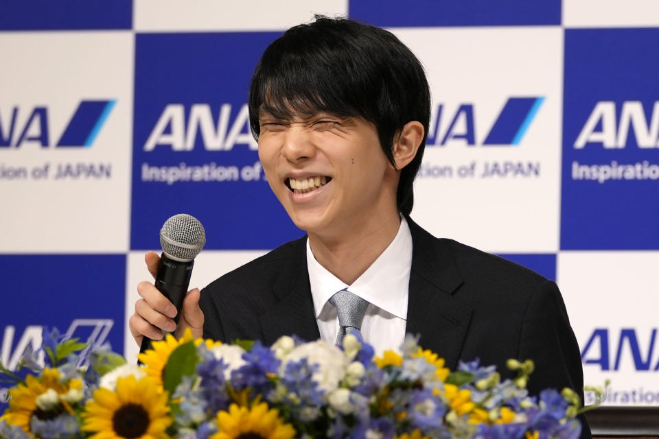 Two-time Olympic champion Yuzuru Hanyu of Japan, smiles during a press conference in Tokyo, Tuesday, July 19, 2022. Hanyu is stepping away from competitive figure skating, he said Tuesday. (AP Photo/Shuji Kajiyama)