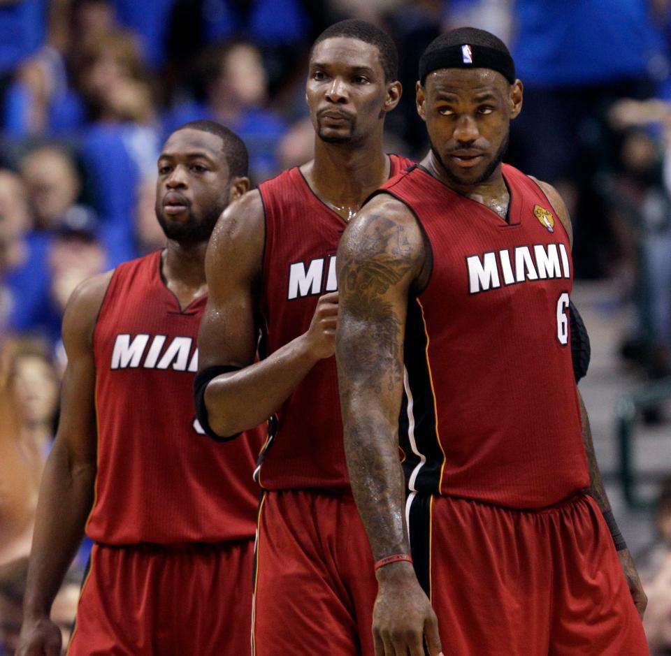 ORG XMIT: DNA145 Miami Heat's Dwyane Wade, left to right, Chris Bosh and LeBron James (6) are seen during a break during the second half of Game 4 of the NBA Finals basketball game Tuesday, June 7, 2011, in Dallas.