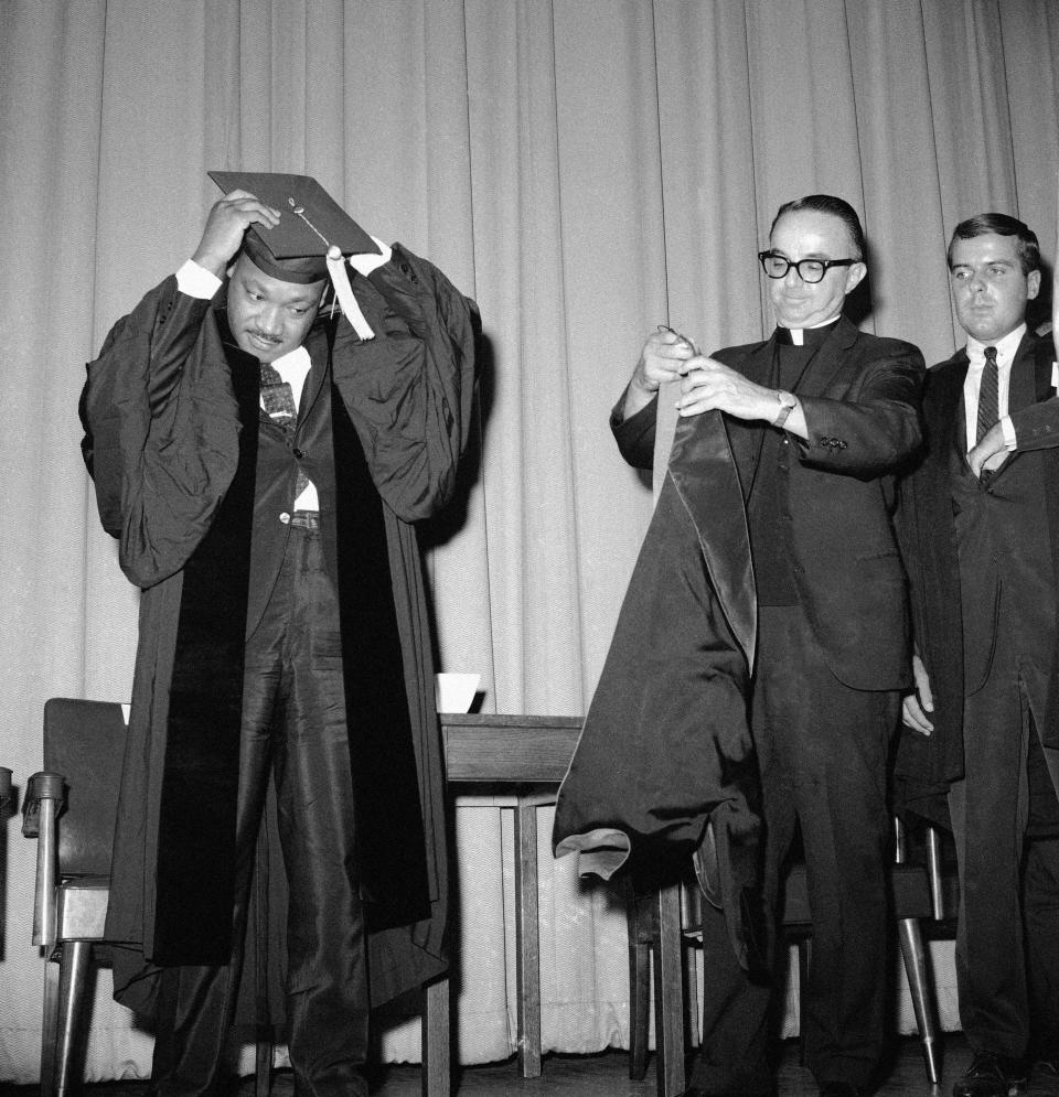 Dr. Martin Luther King is presented with the honorary degree of Doctor of Laws and Letters by Rev. Victor R. Yanitelli, president of Saint Peter's College at the school's Michaelmas Convocation in Jersey City, New Jersey, Sept. 22, 1965. Dr. King also delivered the convocation address at the ceremony.
