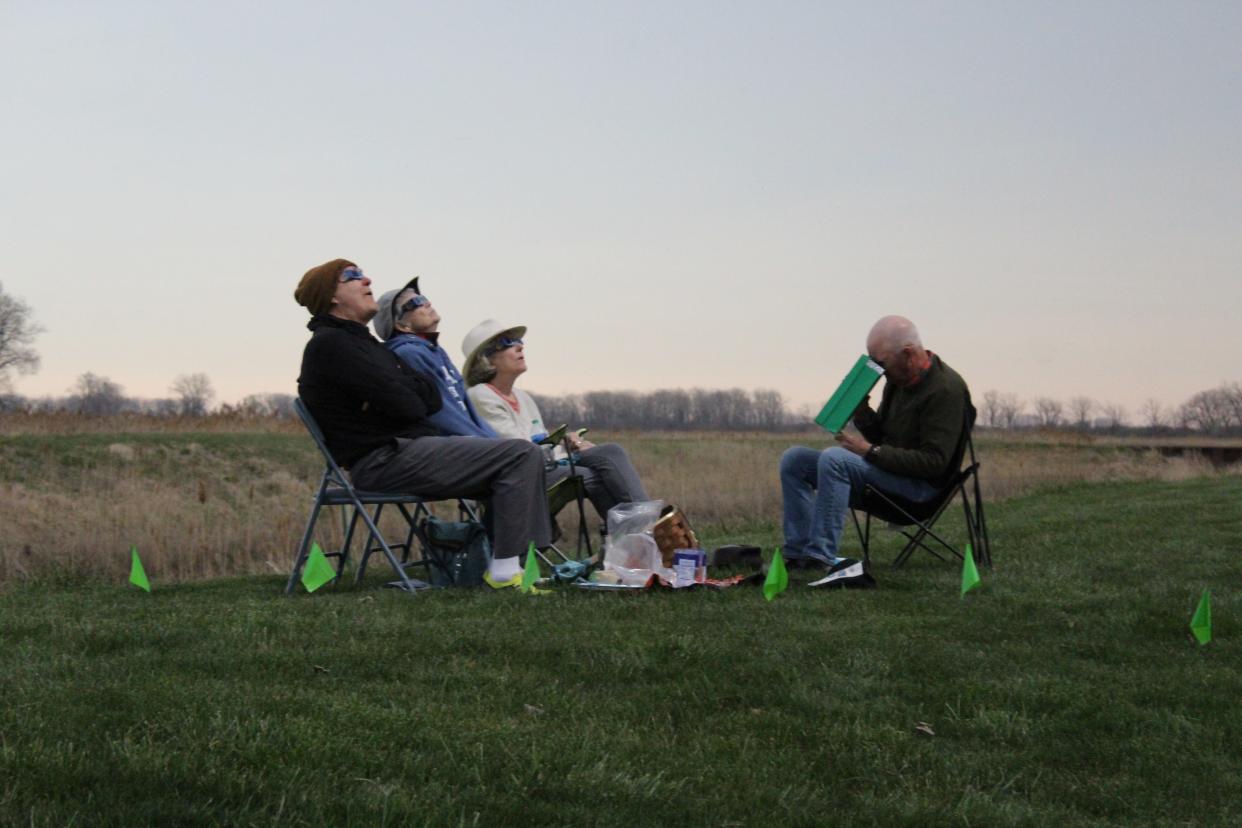 Families and friends gathered at the Erie Marsh Preserve to view the solar eclipse on April 8, 2024.