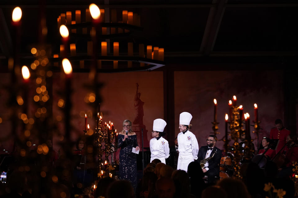 First lady Jill Biden recognizes White House executive chef Cris Comerford, center, and White House executive pastry chef Susie Morrison, right, during a State Dinner with President Joe Biden and French President Emmanuel Macron on the South Lawn of the White House in Washington, Thursday, Dec. 1, 2022. (AP Photo/Andrew Harnik)