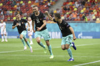 Austria's Stefan Lainer, right, celebrates after scoring his side's first goal during the Euro 2020 soccer championship group C match between Austria and North Macedonia at the National Arena stadium in Bucharest, Romania, Sunday, June 13, 2021. (Marko Djurica/Pool via AP)
