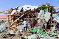 <p>People inspect the damaged shops after a bomb-laden vehicle attacked a marketplace in Moghadishu, Somalia on Feb. 19, 2017. (Photo: Sadak Mohamed/Anadolu Agency/Getty Images) </p>