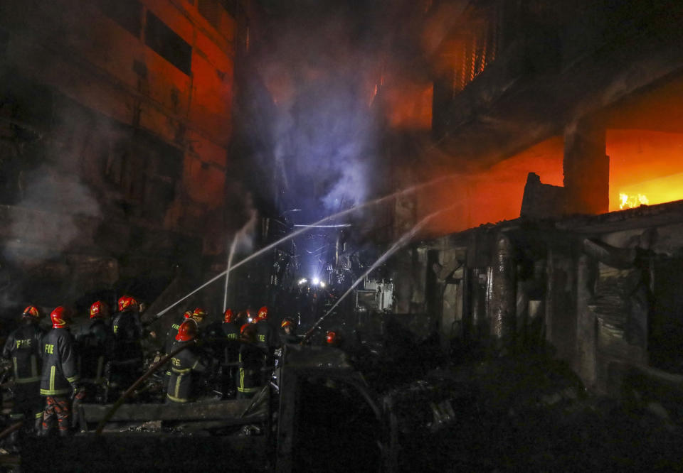Firefighters work to douse flames in Dhaka, Bangladesh,  Feb. 21, 2019. A devastating fire raced through at least five buildings in an old part of Bangladesh's capital and killed scores of people. (Photo:Zabed Hasnain Chowdhury/AP)