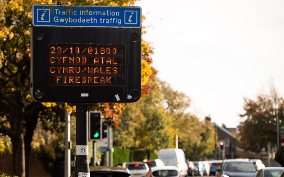 A road sign advising people that the lockdown will begin at 6pm on October 23 in Cardiff - Polly Thomas/Getty Images Europe