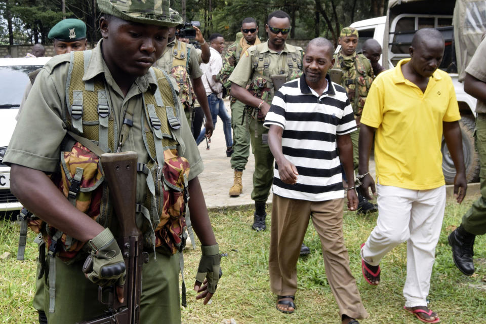 FILE - Cult preacher Pastor Paul Nthenge Mackenzie of the Good News International church, foreground center, and some of his helpers arrive at the Shanzu Law Courts under tight security, in Mombasa, Kenya Thursday Aug. 10, 2023. A Kenyan court on Friday, Nov. 10, 2023 has found Mackenzie, the Kenyan preacher at the center of a doomsday cult in Kenya that led to the deaths of more than 400 people, guilty of operating a studio and distributing films without a license. (AP Photo/Gideon Maundu, File)