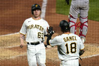 Pittsburgh Pirates' Jack Suwinski (65) is greeted by Ben Gamel after scoring on a sacrifice fly by Oneil Cruz off New York Yankees relief pitcher Lucas Luetge during the sixth inning of a baseball game in Pittsburgh, Tuesday, July 5, 2022. (AP Photo/Gene J. Puskar)
