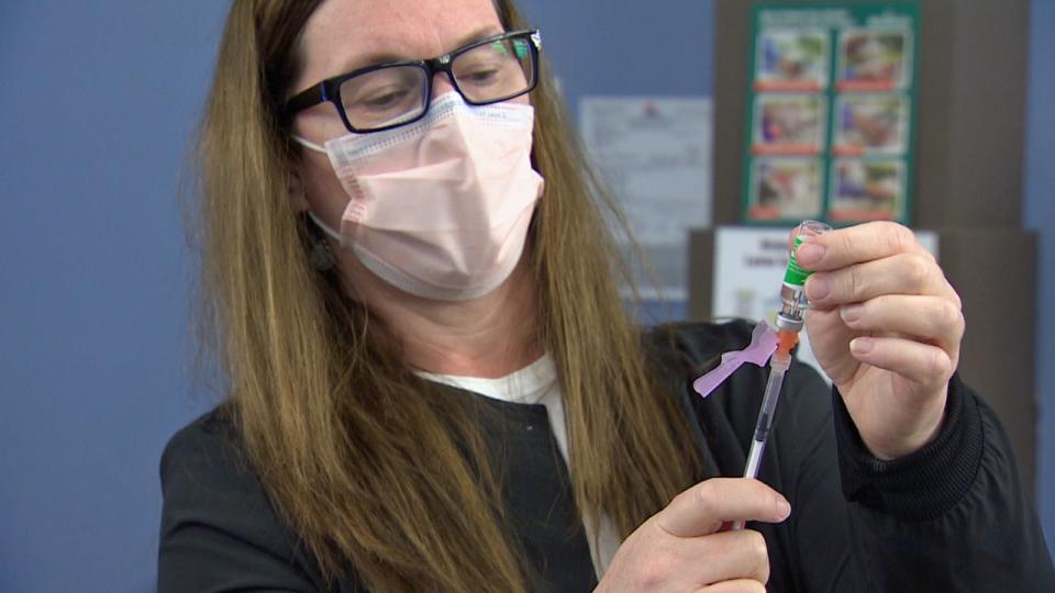 A health-care worker in Fredericton prepares a COVID-19 vaccine.