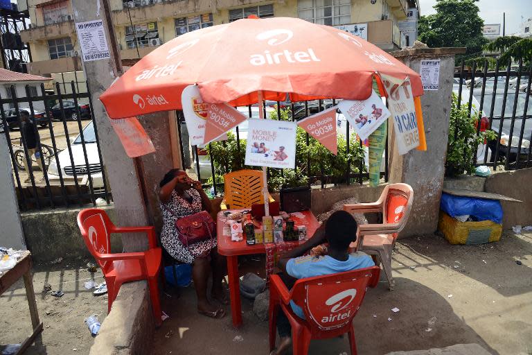 Cellphone providers wait for clients at Computer Village in Lagos, on May 25, 2015