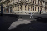 A woman walks through an empty street during a nationwide confinement to prevent the spread of the coronavirus, in the center of Lyon, central France, Sunday, April 5, 2020. The new coronavirus causes mild or moderate symptoms for most people, but for some, especially older adults and people with existing health problems, it can cause more severe illness or death. (AP Photo/Laurent Cipriani)