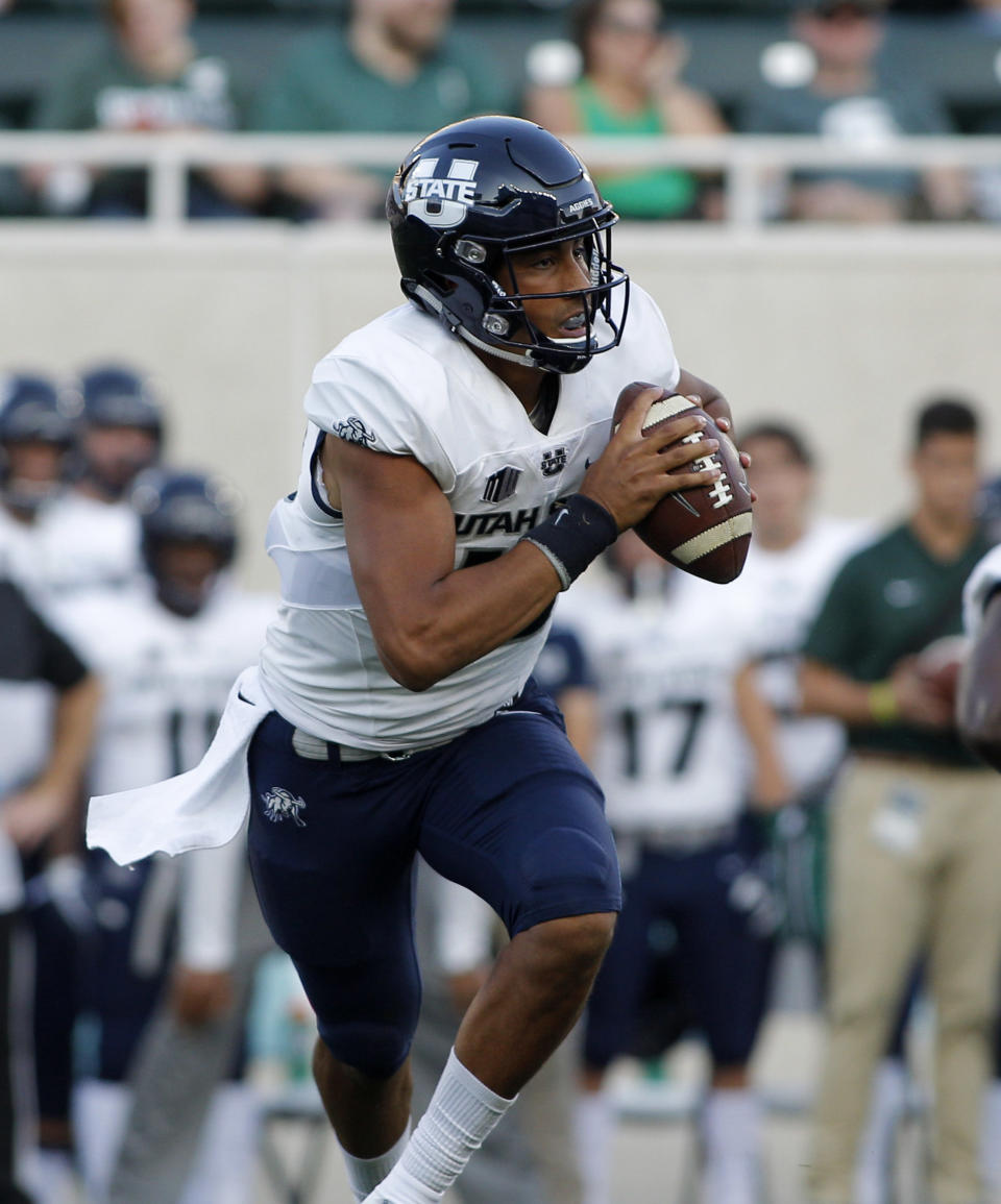 Utah State quarterback Jordan Love rolls out against Michigan State during the first quarter of an NCAA college football game, Friday, Aug. 31, 2018, in East Lansing, Mich. (AP Photo/Al Goldis)