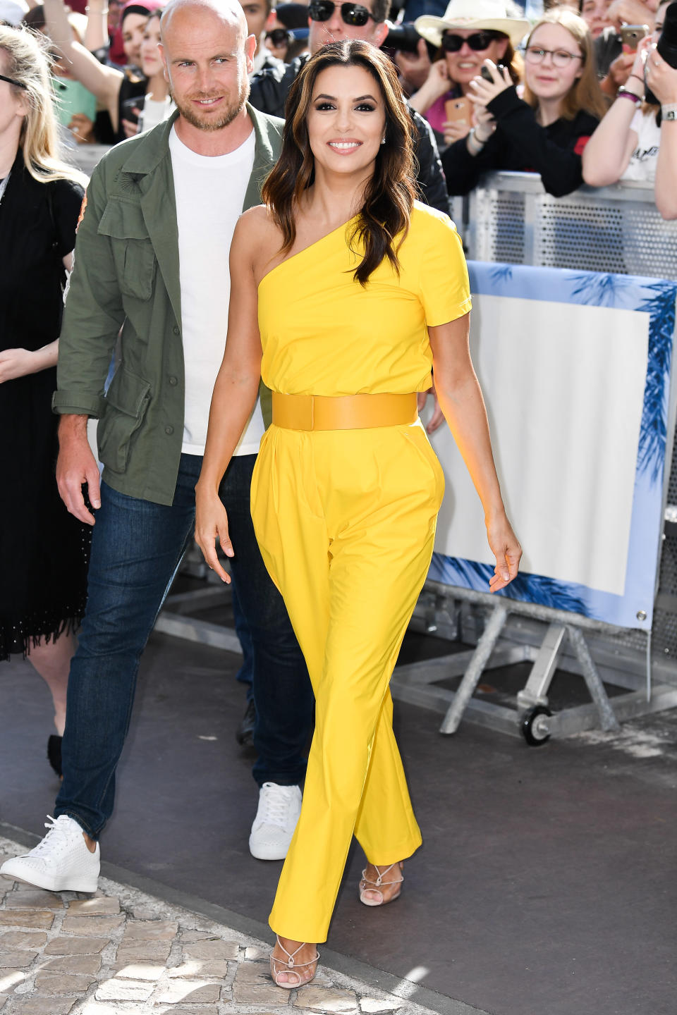 Wearing a yellow Max Mara jumpsuit. [Photo: Getty]