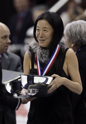 FILE - This Jan. 23, 2009 file photo shows fashion designer Vera Wang holding her engraved silver bowl after being inducted into the United States Figure Skating Hall of Fame at the U.S. Figure Skating Championships in Cleveland. Wang, 63, was honored for her lifetime achievement by the Council of Fashion Designers at its star-studded awards show Monday night. She received the award from her former employer and mentor Ralph Lauren, and she received a standing ovation from her peers. (AP Photo/Amy Sancetta,File)