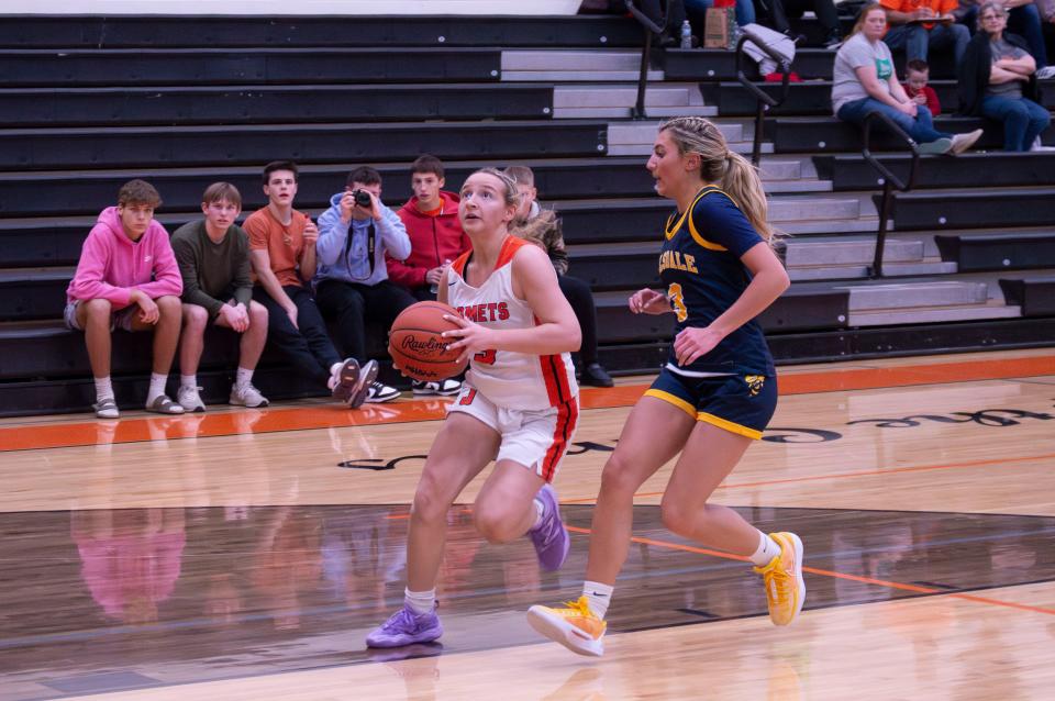 Jonesville junior Haley Mach (3) sinks an easy lay up after a quick transition.