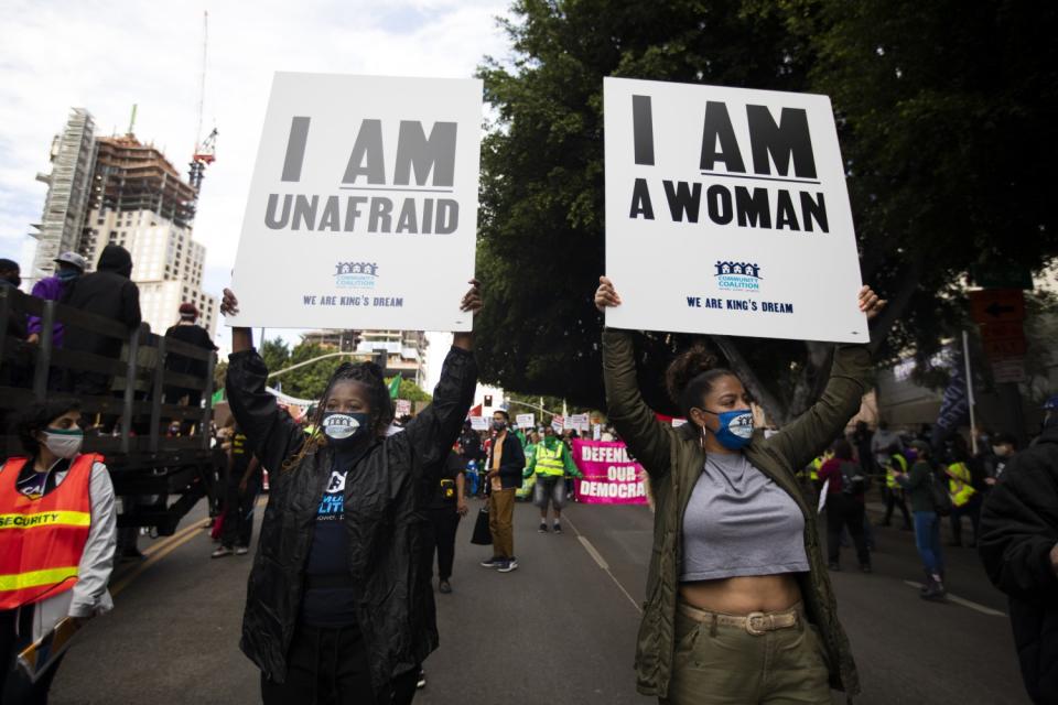 Marlo Jaye, left, and Sade Elhawary, right, are part of the peaceful crowd celebrating outside Los Angeles City Hall