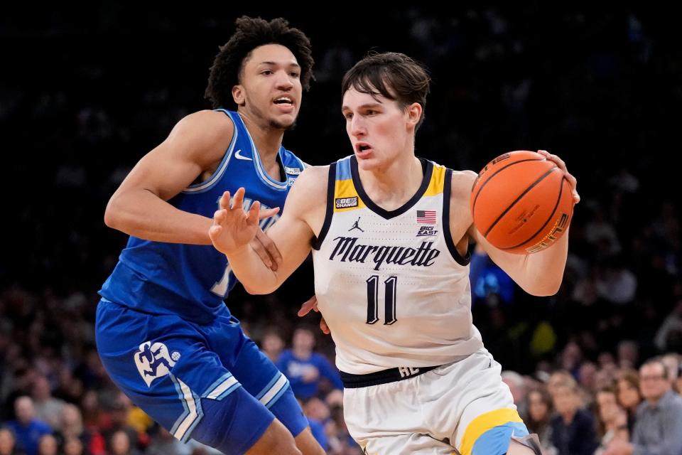 Marquette's Tyler Kolek (11) drives past Xavier's Desmond Claude (1) in the second half of an NCAA college basketball game for the championship of the Big East men's tournament, Saturday, March 11, 2023, in New York. (AP Photo/John Minchillo)