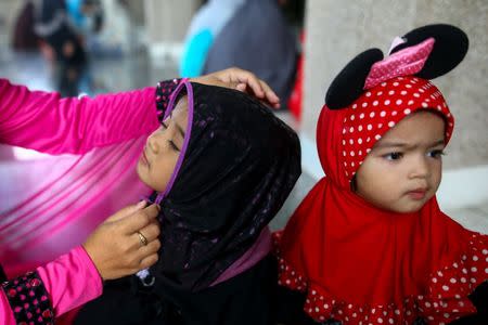 Muslims attend an Eid al-Fitr mass prayer to mark the end of the holy fasting month of Ramadan at a mosque in Bangkok, Thailand, June 25, 2017. REUTERS/Athit Perawongmetha