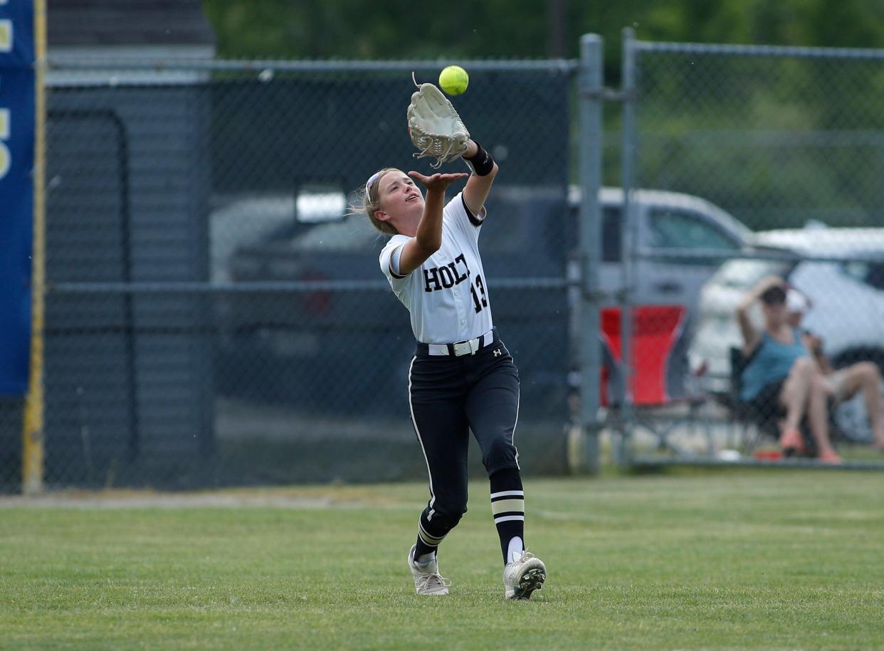 Holt's Eeva Luoma catches a fly ball against DeWitt, Saturday, June 3, 2023, at Grand Ledge High School.