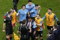 Uruguay players argue with the German referee Daniel Siebert at the end of the World Cup group H soccer match between Ghana and Uruguay, at the Al Janoub Stadium in Al Wakrah, Qatar, Friday, Dec. 2, 2022. (AP Photo/Aijaz Rahi)