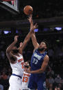 Minnesota Timberwolves center Karl-Anthony Towns (32) shoots over New York Knicks center Mitchell Robinson (23) during the first half of an NBA basketball game, Tuesday, Jan. 18, 2022 in New York. (AP Photo/Noah K. Murray)