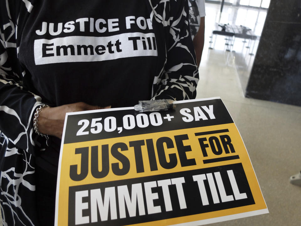 FILE - Deborah Watts, a cousin of Emmett Till, the Black 14-year-old from Chicago who was abducted, tortured and lynched after he allegedly whistled at a white woman in her family store in rural Mississippi, holds a poster and taped thumb drive that allegedly has almost 300,000 signatures on a petition seeking a renewed probe of the 1955 lynching, March 11, 2022, in Jackson, Miss. Legislation that would make lynching a federal hate crime in the U.S. is expected to be signed into law by President Joe Biden. The Emmett Till Anti-Lynching Act was years in the making. (AP Photo/Rogelio V. Solis, File)