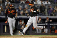 Baltimore Orioles' Adley Rutschman scores on a wild pitch by New York Yankees' Zack Britton during the sixth inning of a baseball game Friday, Sept. 30, 2022, in New York. (AP Photo/Adam Hunger)